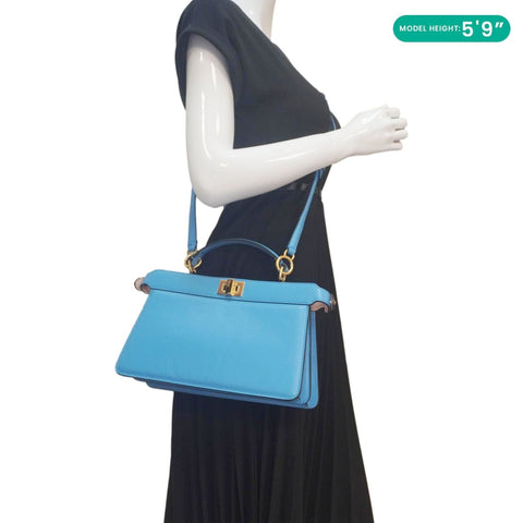 Model holding FENDI Peekaboo I SEE U blue crossbody bag
