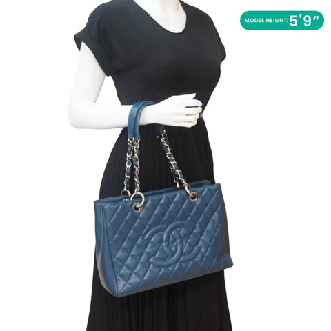 CHANEL Grand Shopping Blue Quilted Leather Tote Bag - Model Holding