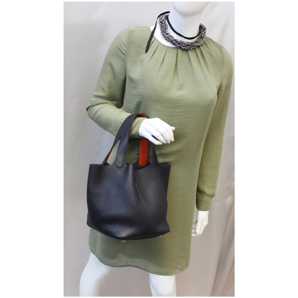 Woman carrying Hermes Picotin Lock 22 MM Leather bag