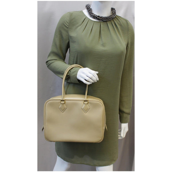 Woman holding Hermes Plume Swift Calfskin Leather Bag