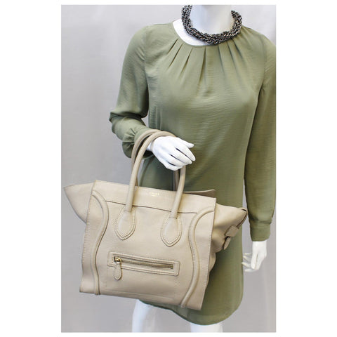 Women holding Celine calfskin mini luggage tote bag