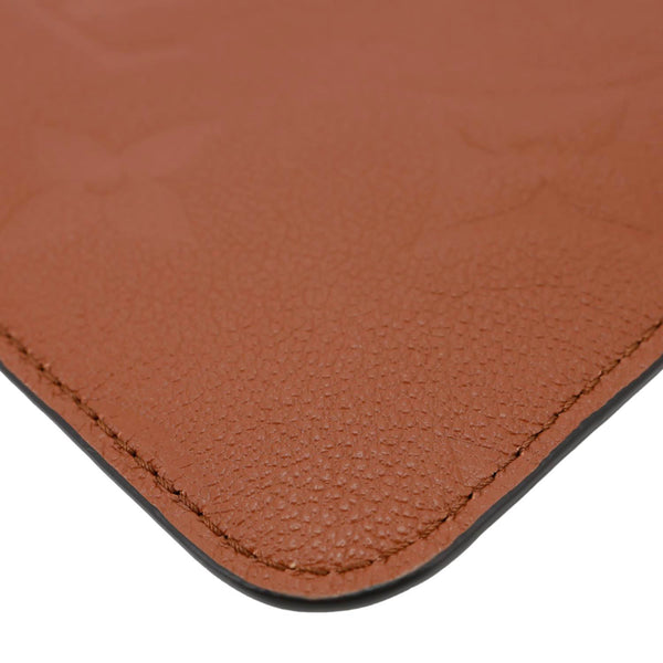 LOUIS VUITTON Neverfull Pochette Giant Monogram Empreinte Leather Wristlet Brown
