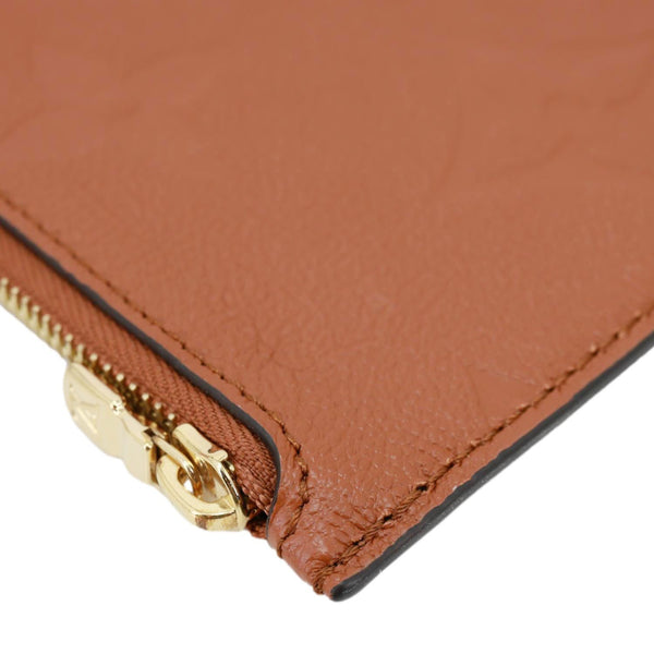 LOUIS VUITTON Neverfull Pochette Giant Monogram Empreinte Leather Wristlet Brown