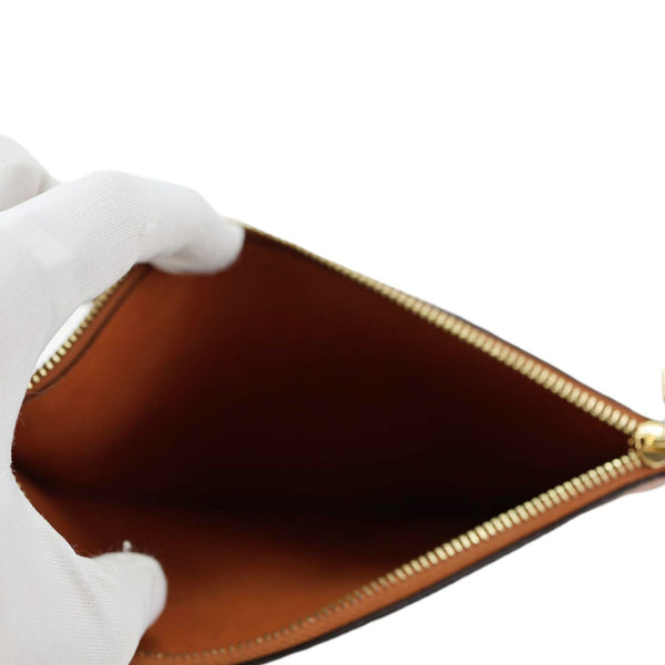 LOUIS VUITTON Neverfull Pochette Giant Monogram Empreinte Leather Wristlet Brown