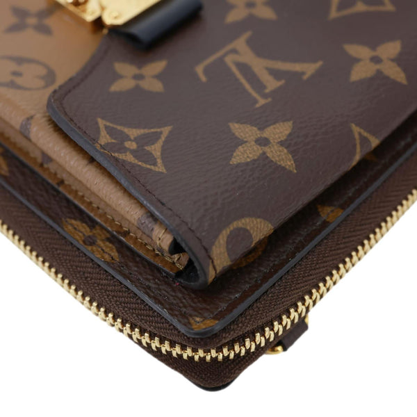 LOUIS VUITTON Metis Reverse Monogram Canvas Vertical Zippy Chain Wallet Brown