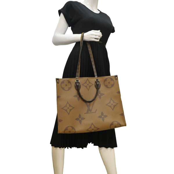 LOUIS VUITTON Onthego GM Monogram Marvel Brown Shoulder bag  with body view
