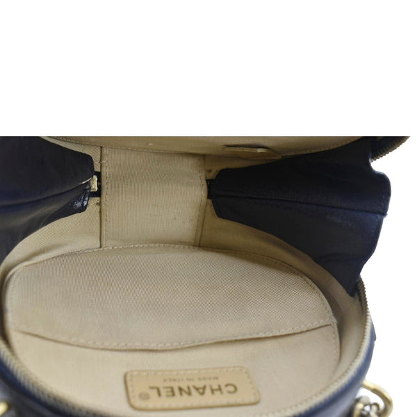 CHANEL Navy Glazed Round As Earth Leather Crossbody Bag  with in side view 