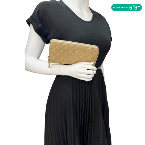 Chanel CC Metallic Gold Quilted Leather Zip Around Wallet - Model Holding