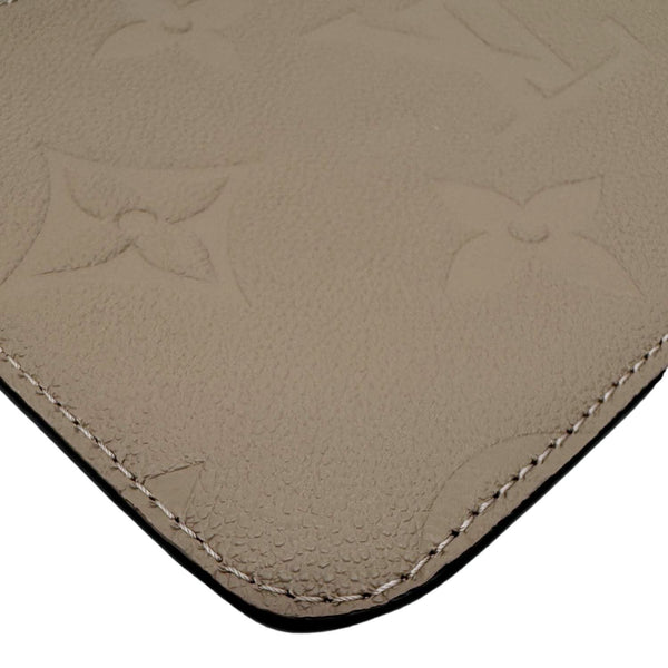LOUIS VUITTON Neverfull Pochette Giant Monogram Empreinte Leather Wristlet Beige