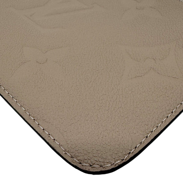 LOUIS VUITTON Neverfull Pochette Giant Monogram Empreinte Leather Wristlet Beige
