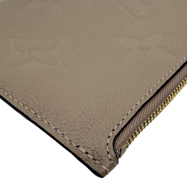 LOUIS VUITTON Neverfull Pochette Giant Monogram Empreinte Leather Wristlet Beige