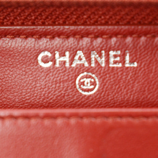 CHANEL Zippy Camellia Embossed Leather Wallet Red