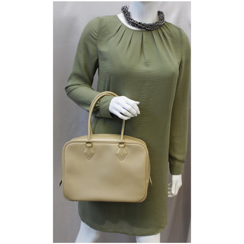 Woman holding Hermes Plume Swift Calfskin Leather Bag