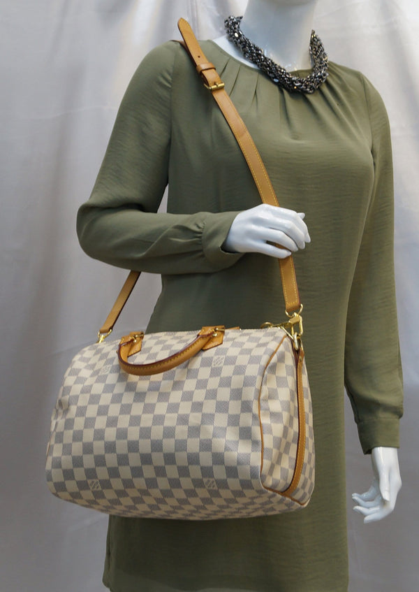 Woman carrying LV Damier Azur Speedy 30 Bandouliere Bag