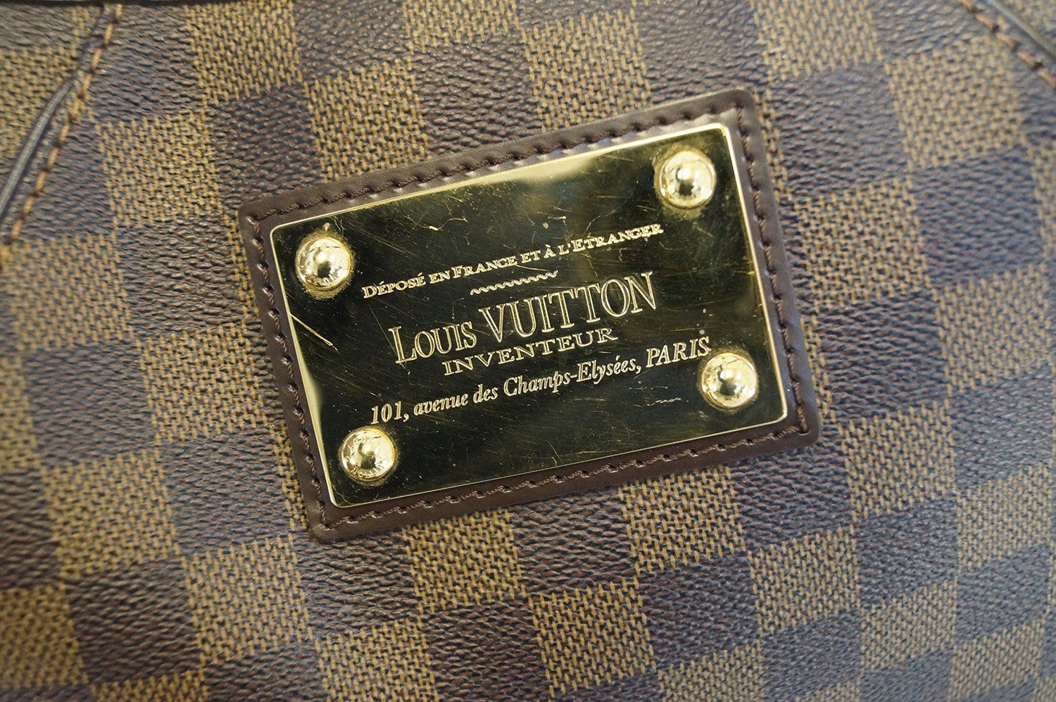 louis vuitton backpack with gold plate on front