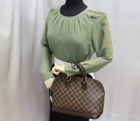LOUIS VUITTON Damier Ebene Alma Brown Handbag